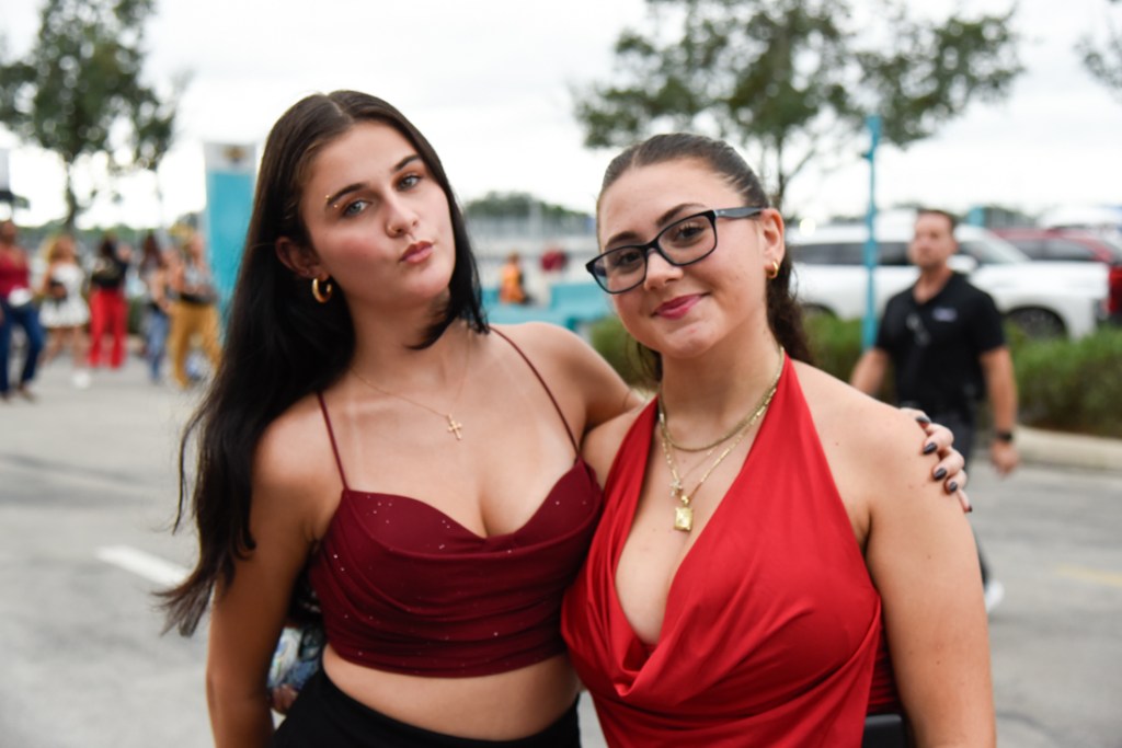 Photo of fans wearing red and black outfits at the Bruno Mars' The Romantic Tour concert in Miami.