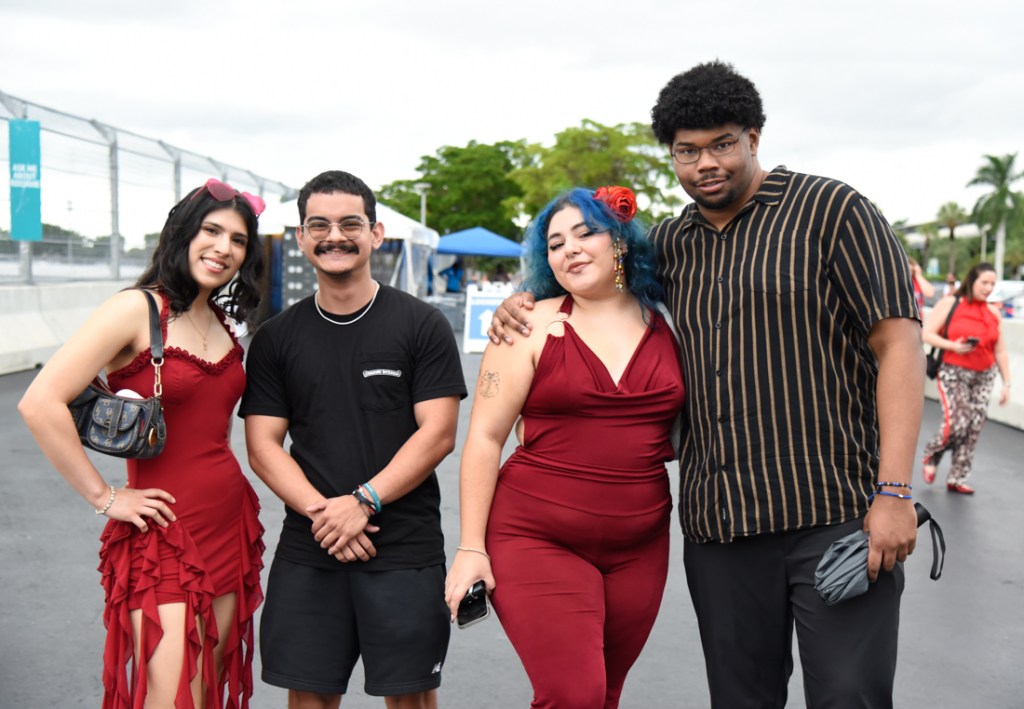 Photo of fans wearing red and black outfits at the Bruno Mars' The Romantic Tour concert in Miami.