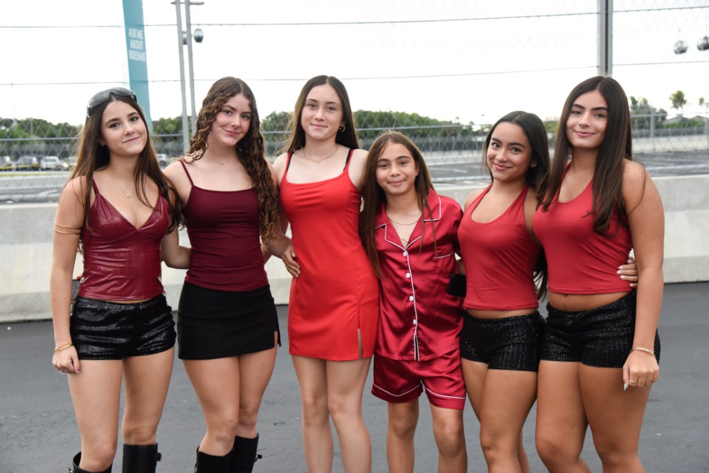 Photo of fans wearing red and black outfits at the Bruno Mars' The Romantic Tour concert in Miami.