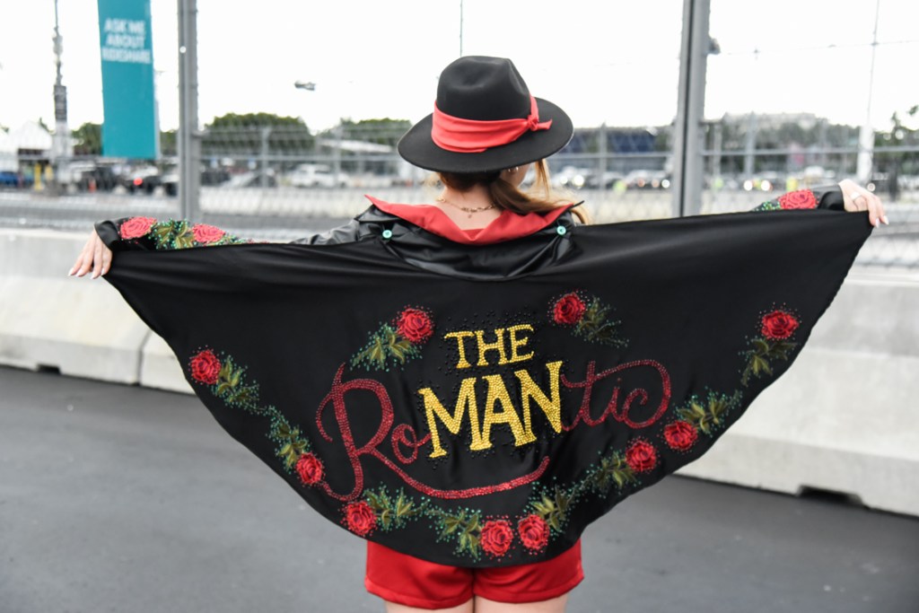 Photo of a Bruno Mars fan wearing a cape that reads "The Man"