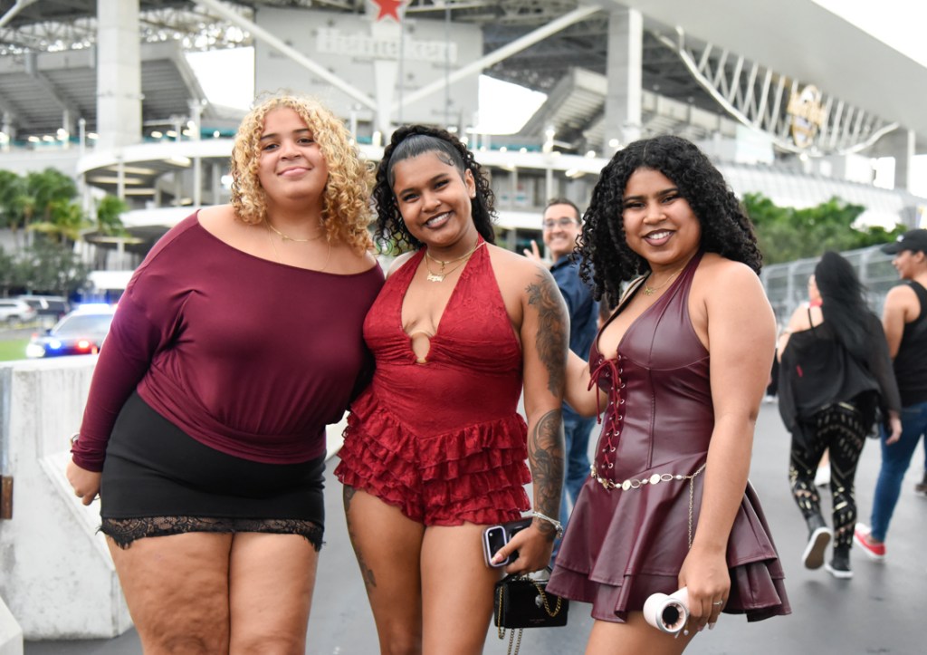 Photo of fans wearing red and black outfits at the Bruno Mars' The Romantic Tour concert in Miami. 