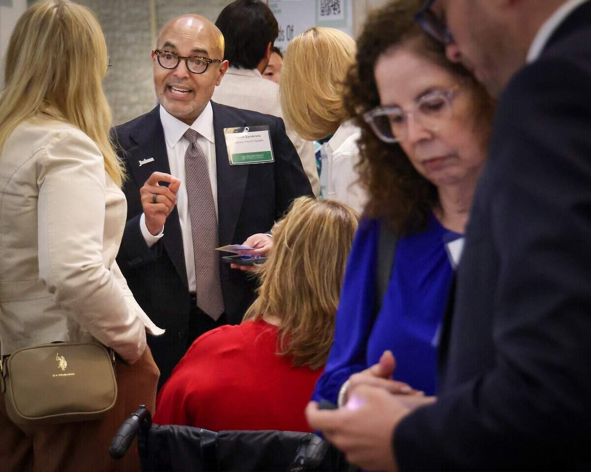 David Zambrana, president and CEO of Jackson Health System, speaks with attendees before the panel discussion on the proposed Homestead property tax exemption during the Greater Miami Chamber of Commerce Trustee Luncheon in Miami on Wednesday, Sept. 16, 2026.