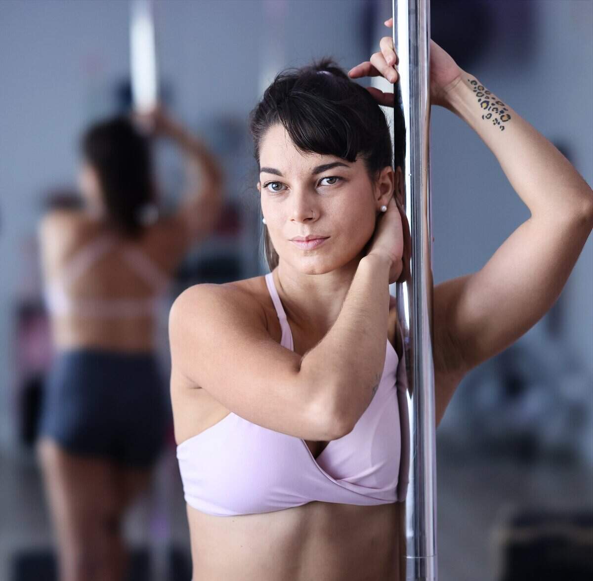 Mariana Alom, 32, is photographed at The WildCat Room, her dance studio in Miami Beach, on Monday, July 20, 2026. Alom, a Cuban immigrant, came to the United States through family reunification after first moving to Brazil to pursue her dream of opening a pole dancing studio.