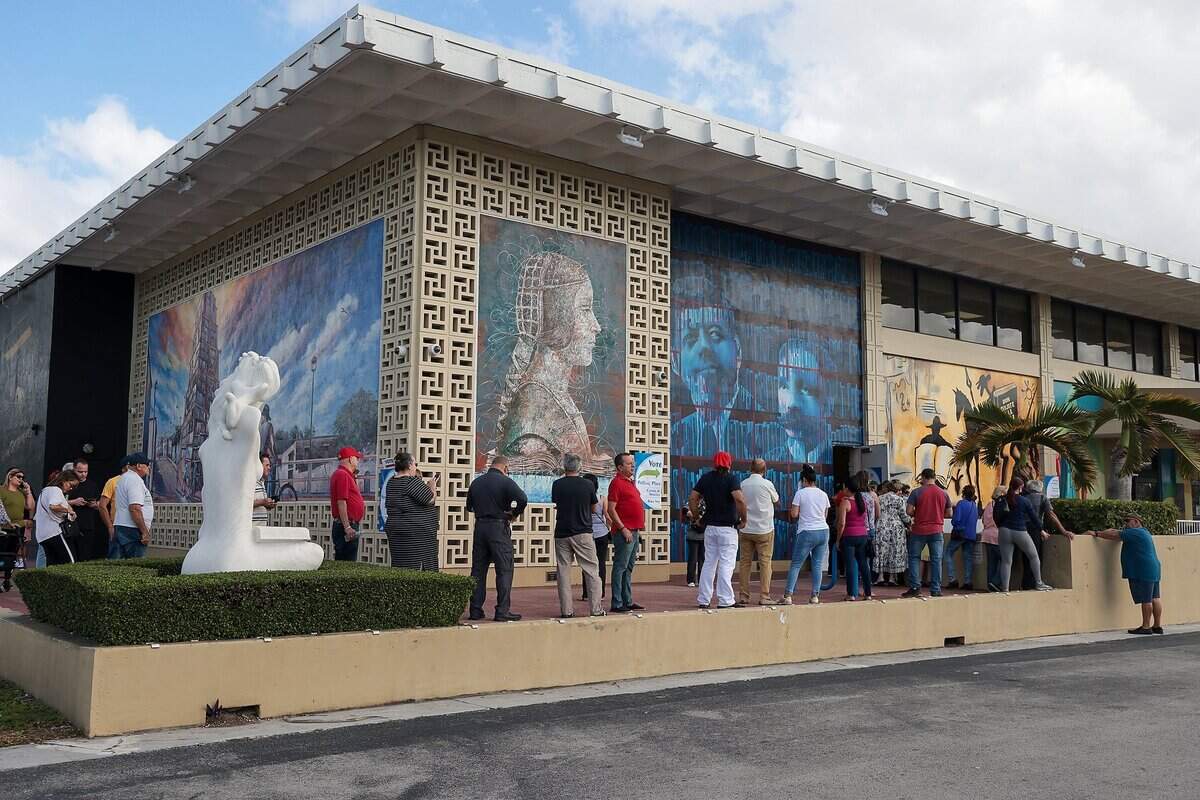 Hialeah residents stand in line as they and cast their ballots at the John F. Kennedy Library in Hialeah, Florida on Nov. 8, 2022.