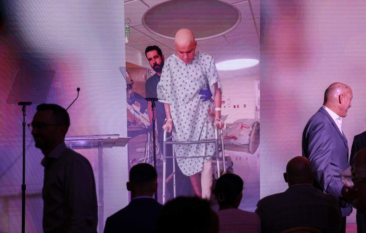 A photo of Tristan Milano taken during his 2025 cancer treatment is displayed as guest find their seats at the Nicklaus Children's Hospital groundbreaking ceremony Thursday, Sept. 10, 2026, for the future Helen & Jacob Shaham Cancer & Blood Disorders Institute in Miami, Fla.