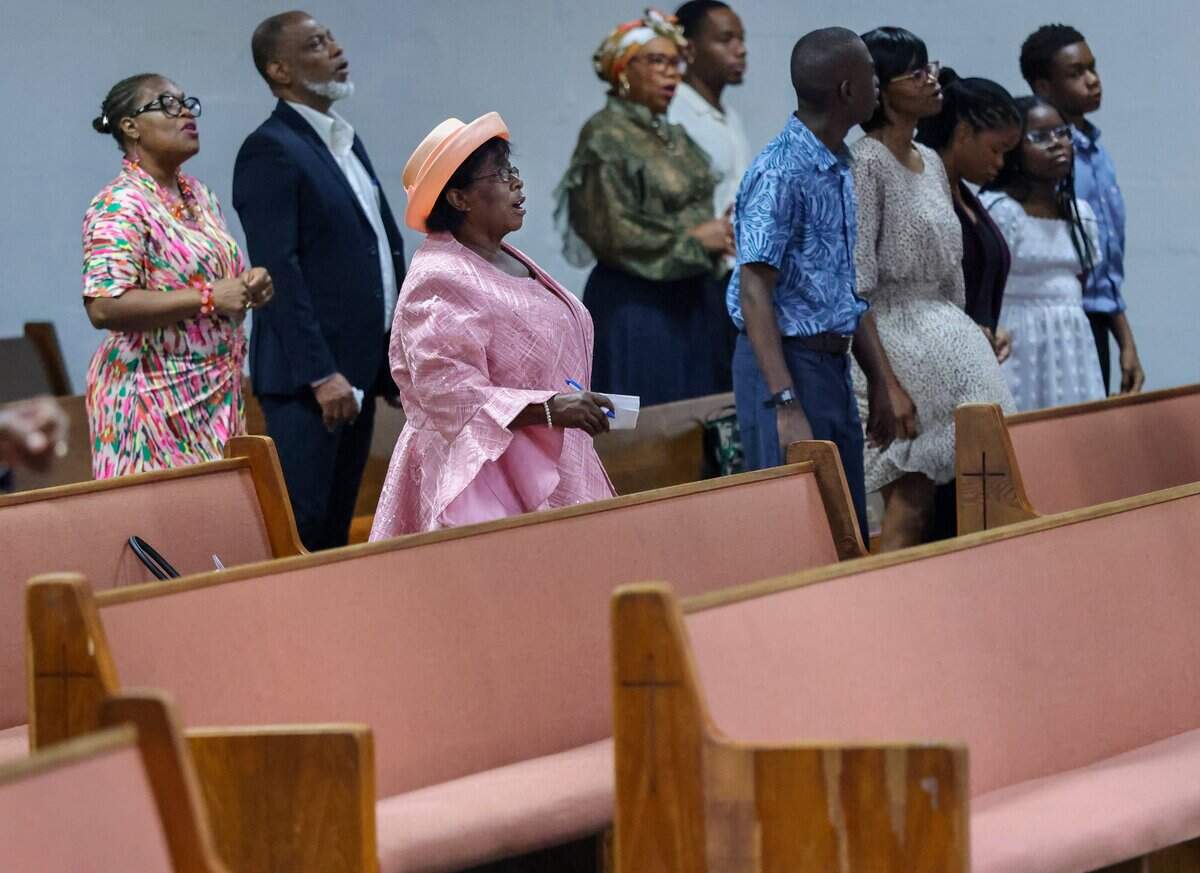 Congregants stand in prayer and song during Sunday service at Bethel Evangelical Baptist Church in Miami Gardens, Fla., on Sunday, Sept. 13, 2026. Attendance has dropped about 20% since Temporary Protected Status ended for more than 300,000 Haitians.