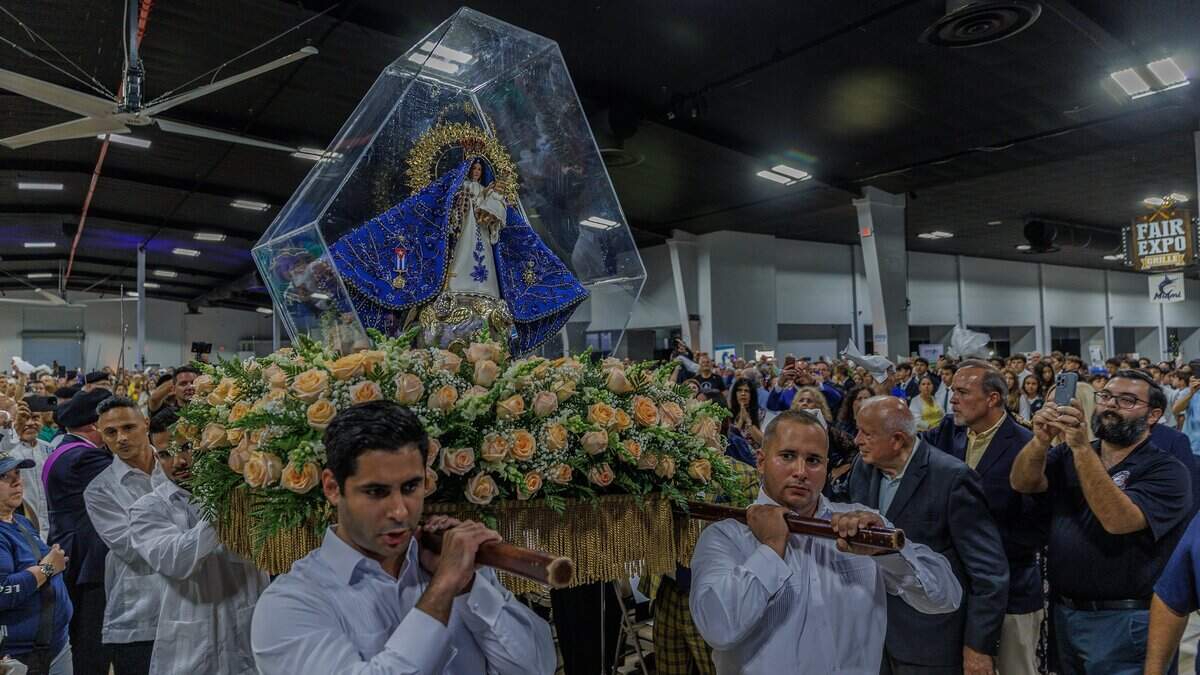 A group of men carried the blessed statue of Our Lady of Charity through a crowd of devotees and parishioners during the celebration of a Solemn Mass celebrating the 65th Anniversary of the Arrival of the Image of Our Lady of Charity in Miami, presided over by Reverend Thomas Wenski, Archbishop of Miami celebrated at the Miami-Dade Fair & Exposition, in West Miami, on Tuesday September 08, 2026.