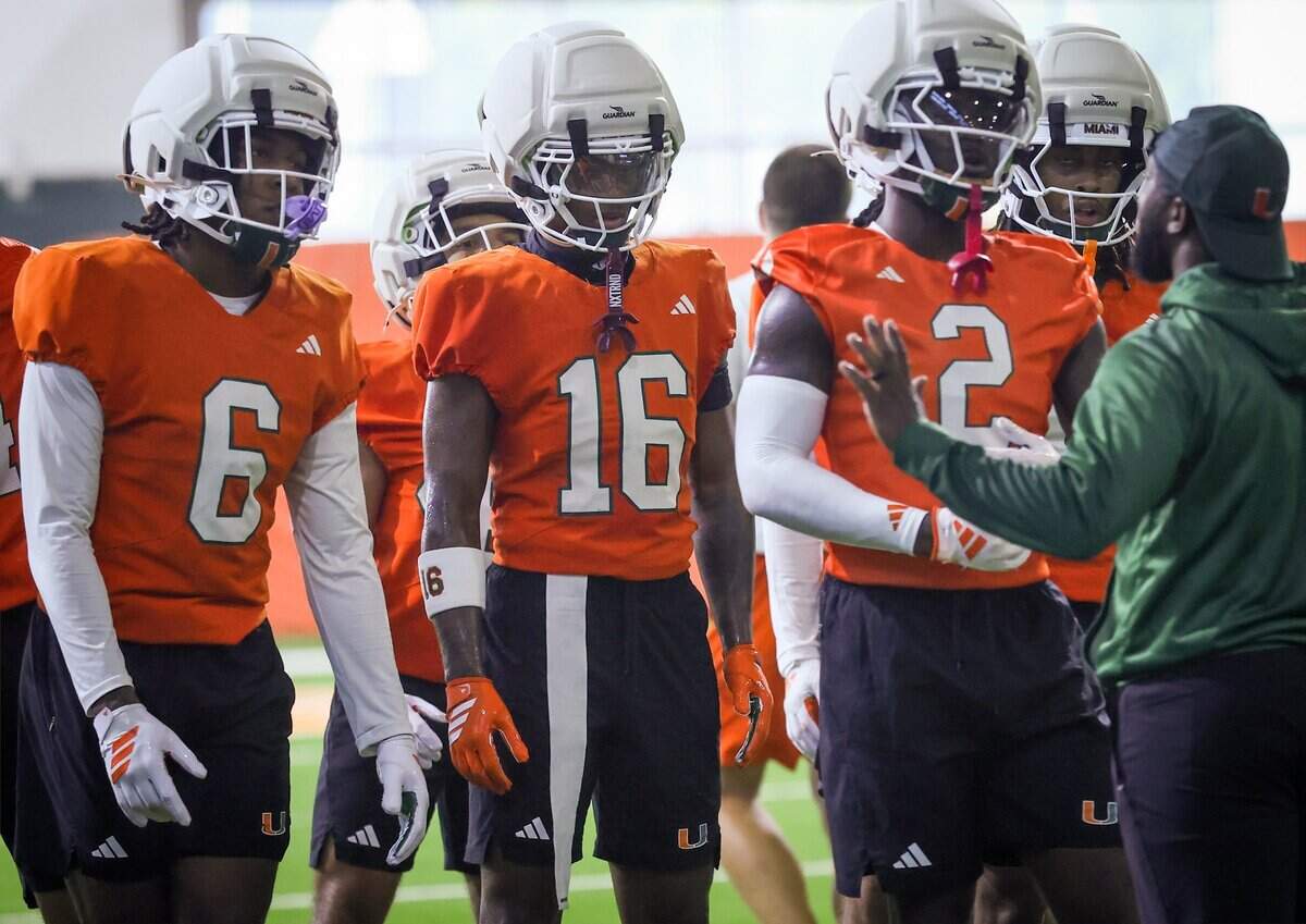 Defensive backs Xavier Lucas (6), Ja'Boree Antoine (16), and Damari Brown (2) closely listens to drill instructions as Miami Hurricanes football team practiced on Wednesday, Aug. 5, 2026, at the Carol Soffer Indoor Practice Facility in Coral Gables, Fla.