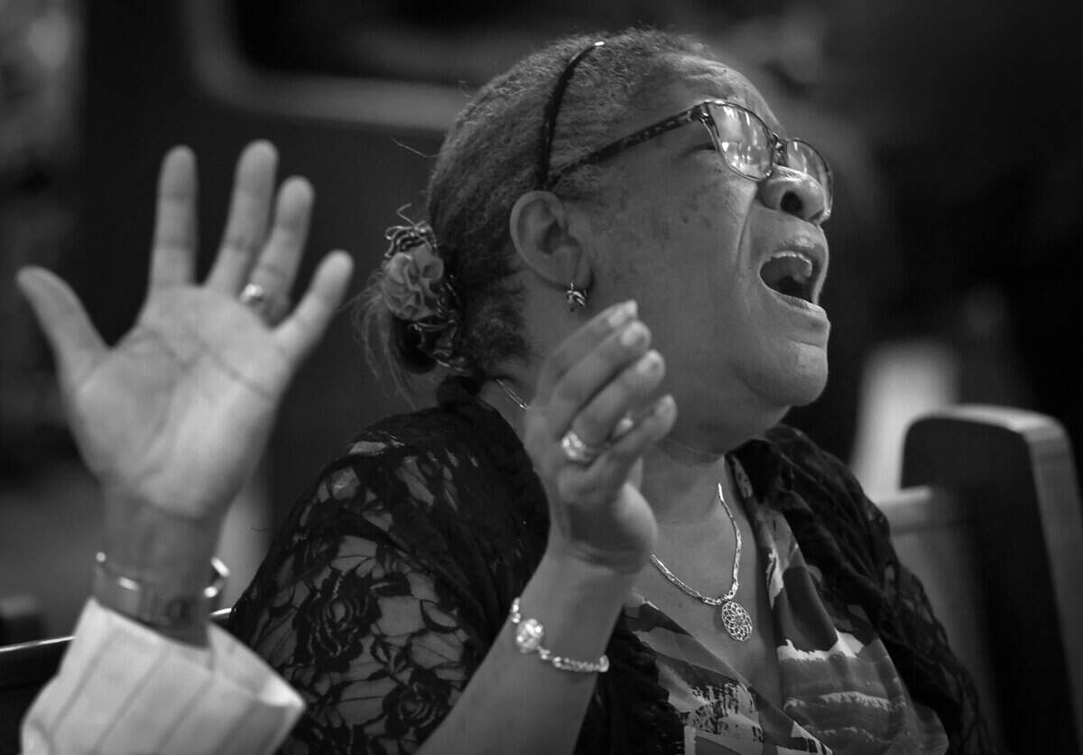 A Bethel Evangelical Baptist Church congregants raise their hands in prayer while the congregation cope with the burden left by the end of Temporary Protected Status, which has left tens of thousands of Haitians in South Florida in immigration limbo. Fearing for their safety, many have made the difficult decision to stay home on Sunday, September 13, 2026, in Miami Gardens, Fla. .