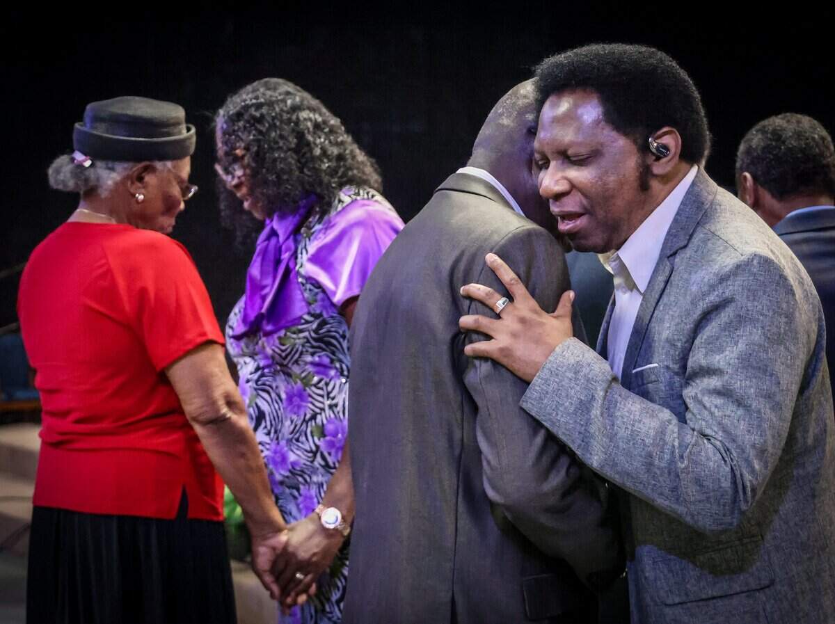 Congregants place their hands on one another in prayer during a service at Bethel Evangelical Baptist Church in Miami Gardens, Fla., on Sunday, Sept. 13, 2026. The congregation is coping with the burden left by the end of Temporary Protected Status, which has left tens of thousands of Haitians in South Florida in immigration limbo. Fearing for their safety, many have made the difficult decision to stay home on Sundays.