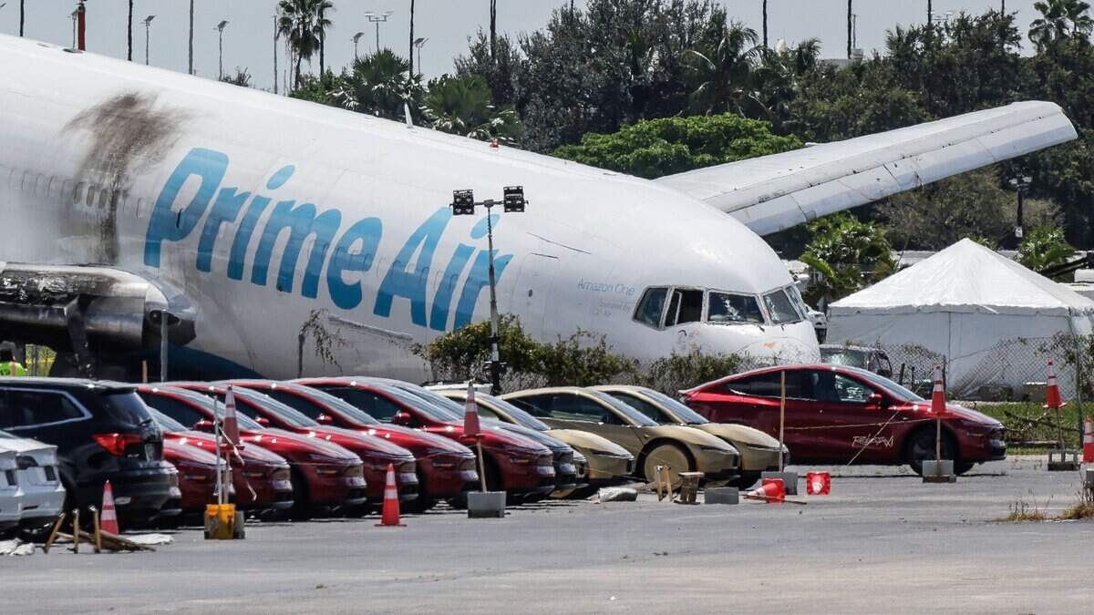 Investigations continue on the scene on Tuesday, September 8, 2026, after an Amazon Prime Air Boeing 767 crashed off a runway west of Miami International Airport in Miami on Sunday.