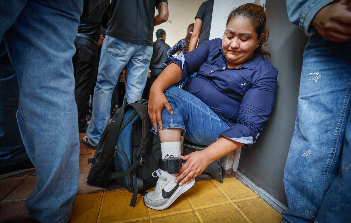 Mayerling Alvarado of Nicaragua wears an ankle bracelet as she waits for her immigration appointment outside of  Miami Immigration Court in downtown Miami on Wednesday, September 9, 2026.