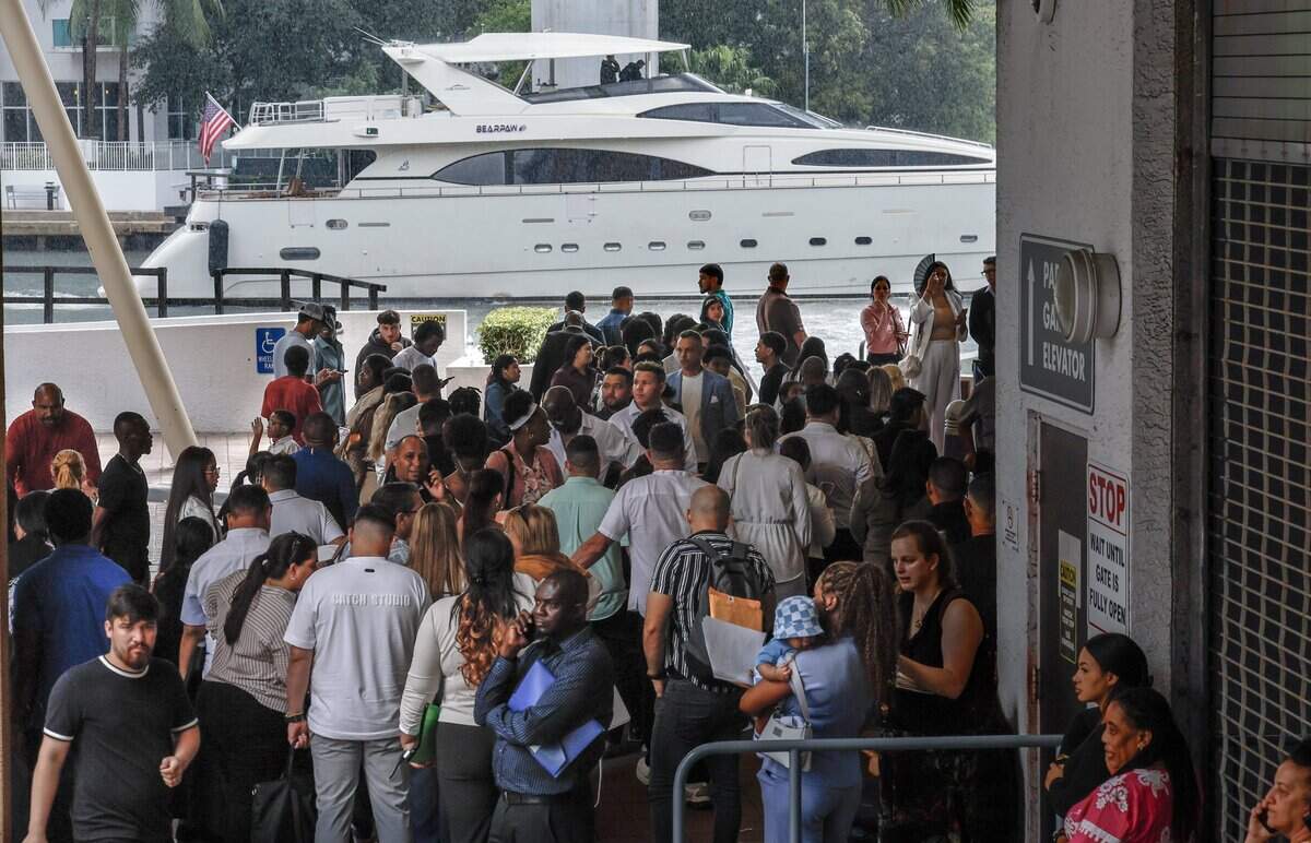 Immigrants wait for appointments outside at Miami Immigration Court as a luxury yacht along side the Miami River in downtown Miami on Wednesday, September 9, 2026.