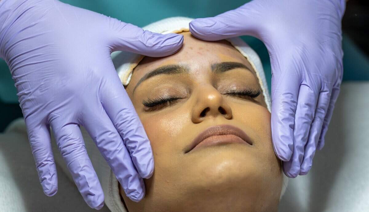 Heidy Martínez, owner of Mimos Skincare, massages customer Zurelis Bravo's face during a skincare treatment at her store in Miami, Fla., on Friday, July 17, 2026.