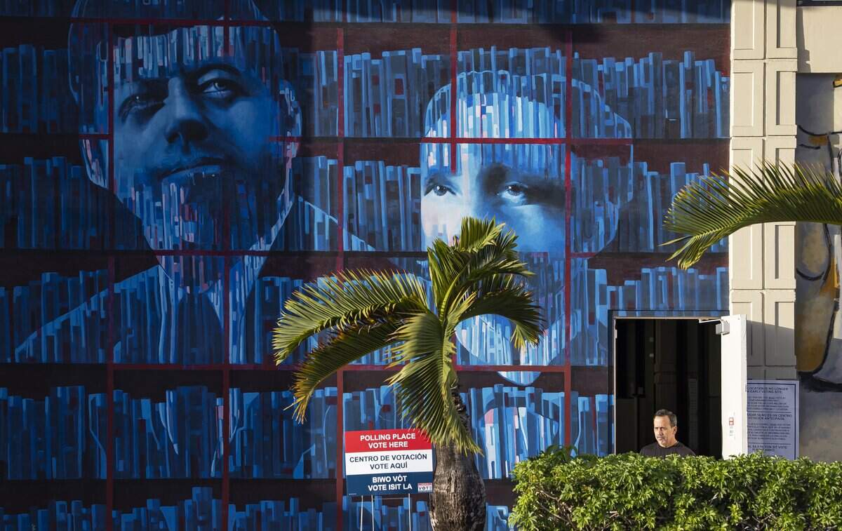 A man is seen at the entrance of a polling place during Election Day at the John F. Kennedy Library on Tuesday, Nov. 4, 2025, in Hialeah, Fla.