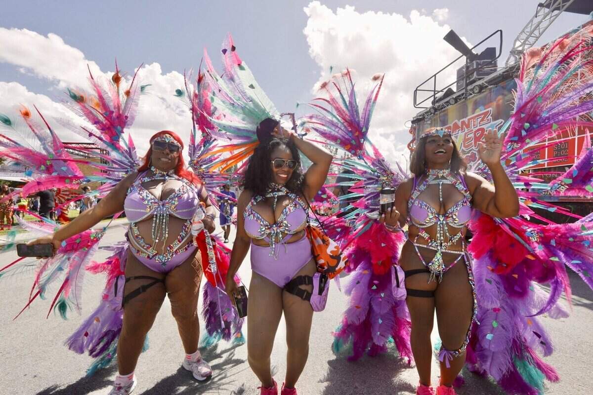 Festival goers walk in matching outfits during Miami Carnival on Sunday, Oct. 12, 2025, at the Miami-Dade County Fair & Exposition.