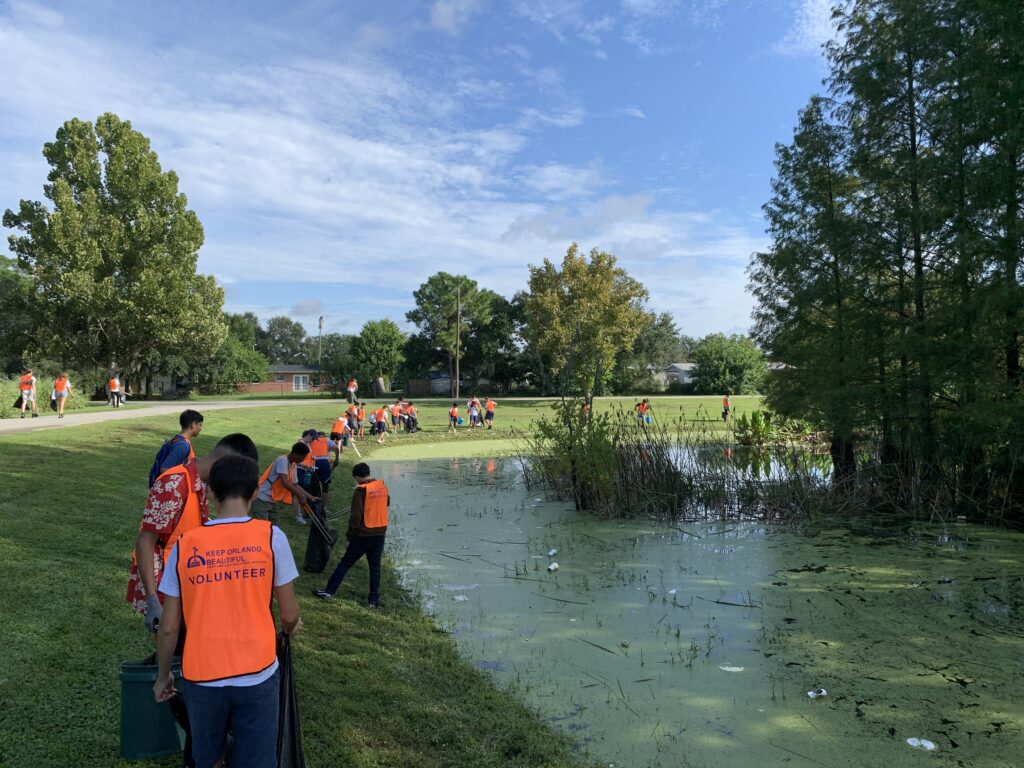 people cleaning a lake