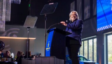 Santiago Corrada smiles while speaking at a podium during Visit Tampa Bay’s annual meeting.