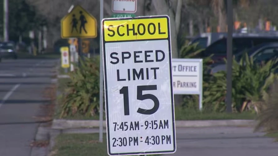 A sign shows the speed limit around Neptne Beach Elementary School, where cameras have been used to monitor drivers.