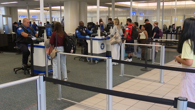 TSA officers work at security checkpoints at the Orlando International Airport. (Spectrum News)