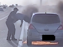 Southlake Police Dept. Corp. Joshua Swisher rescues male drive from burning car on side of highway.