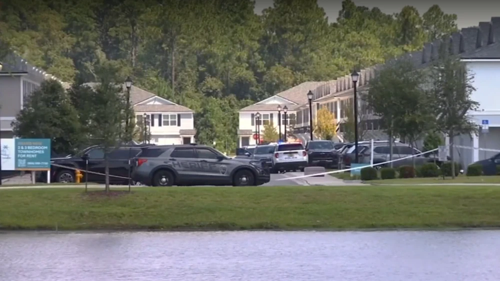 Police cars are shown outside the scene of a child's drowning.