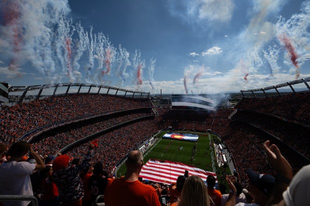 Denver Broncos fans get on their feet as fireworks go...