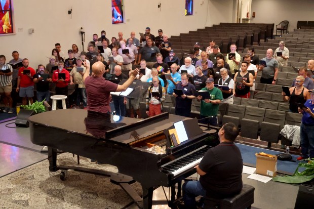 Assistant conductor Anthony Cabrera and principal accompanist Darren Matias lead a rehearsal of the Gay Men's Chorus of South Florida on June 2 at the Sunshine Cathedral in Fort Lauderdale. (Mike Stocker/South Florida Sun Sentinel)