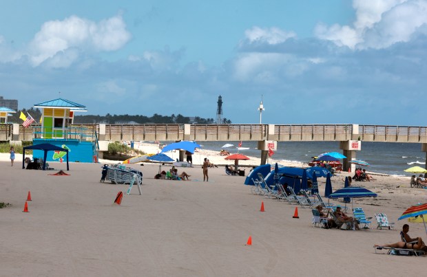 Signs at Pompano Beach designate it as a sensory accessible beach on Friday, Sept. 25, 2026. A new initiative makes six major beaches in Broward County more accessible for people with sensory sensitivities, such as autism, dementia, stroke, and PTSD, by offering sensory bags equipped with noise-canceling headphones, fidget tools, verbal cue cards, and strobe-reduction sunglasses at lifeguard stations. (Mike Stocker/South Florida Sun Sentinel)
