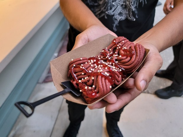 Meat Grinder Red Velvet: the name says it all. Disturbing, delicious and delightful for fans of Halloween Horror Nights' gory, themed plates. It's drizzled in raspberry "blood" and studded with puffed-rice "maggots." Happy Halloween! (Photo courtesy Lisa Wilk/TasteCookSip.com)