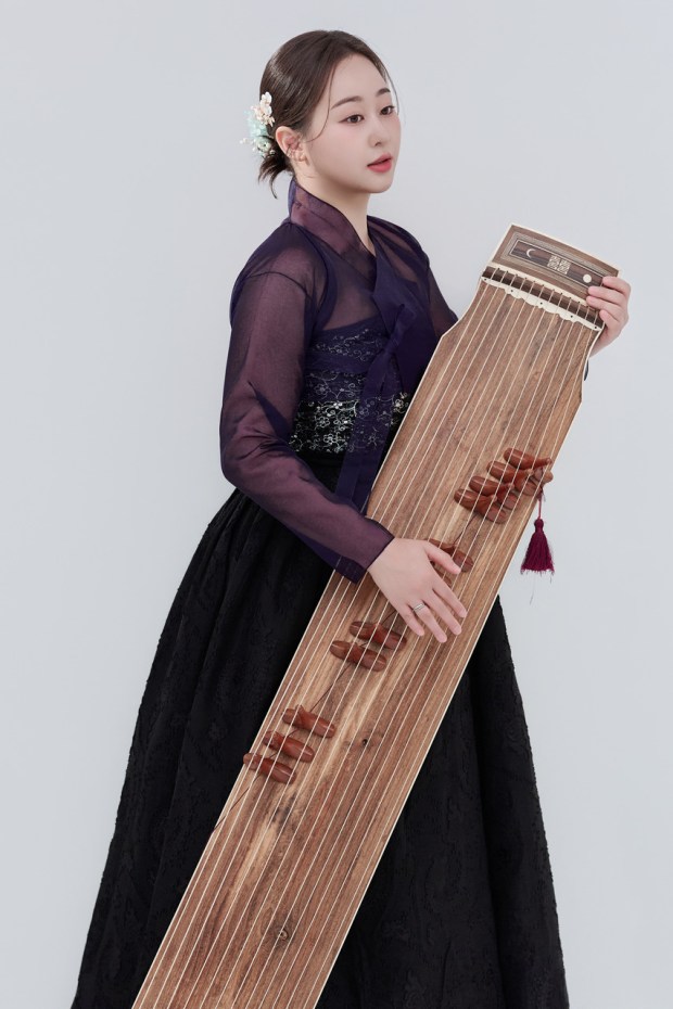 Korean musician Ji Eun Kim cisplays a gayageum, an instrument that will be part of the "Voices of Korea" program at the Milk District Salon at 1U. (Courtesy Milk District Salon)