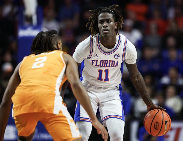 Florida guard Denzel Aberdeen handles the ball ball against Tennessee's Chaz Lanier during the Gators' 73-43 rout of the top-ranked Volunteers Jan. 7 at Stephen C. O'Connell Center in Gainesville. (Photo by James Gilbert/Getty Images)