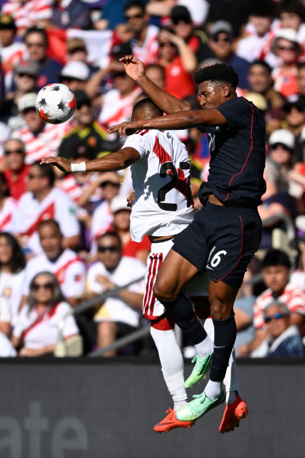 Peru's Jhonny Vidales (27) and United States defender Alex Freeman (16) compete for a head ball during the first half of an international friendly soccer match, Saturday, Sept. 26, 2026, in Orlando, Fla. (AP Photo/Phelan M. Ebenhack)
