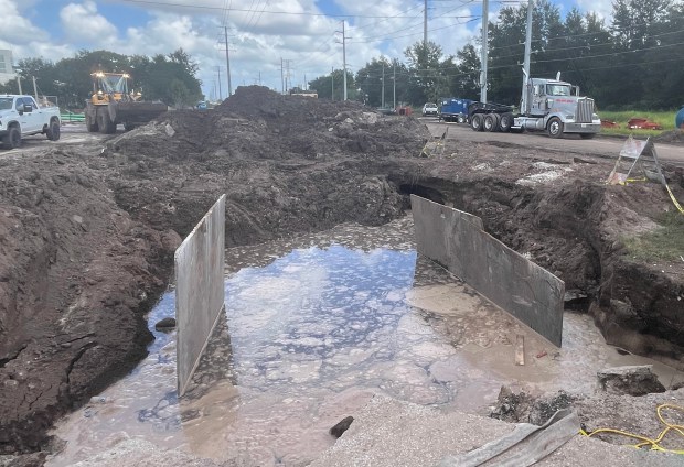 A work crew pumps what appears to be sewage out of a large hole in the ground at the site of a wastewater spillage in Orange County near Aquatica on Thursday, September 17, 2026. About 342,000 gallons of sewage was spilled. (Silas Morgan/Orlando Sentinel)