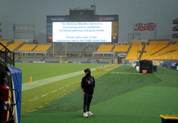 A UCF staff member looks at the skies as his team waits for weather to clear to take on Pitt at Acrisure Stadium, Saturday, Sept. 12, 2026, in Pittsburgh. (Matt Freed/Pittsburgh Post-Gazette)