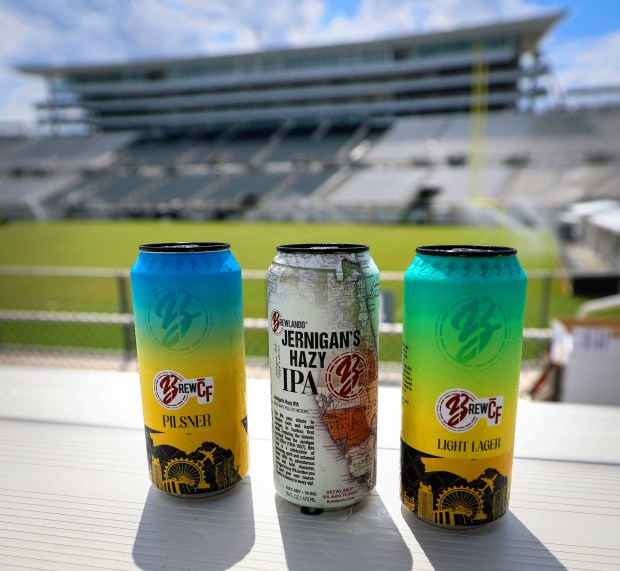 Brewlando's lineup of University of Central Florida-themed beers a pilsner, IPA and light lager at the Acrisure Bounce House on campus, Aug. 21, 2026. The brewery is debuting its "BREW-CF" beers at the stadium in time for UCF's home opener Sept. 7. (Joe Burbank/Orlando Sentinel)