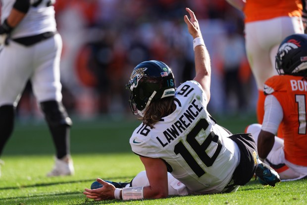 Jacksonville Jaguars quarterback Trevor Lawrence (16) reacts to a play in the second half of an NFL football game against the Denver Broncos in Denver, Sunday, Sept. 20, 2026. (AP Photo/David Zalubowski)