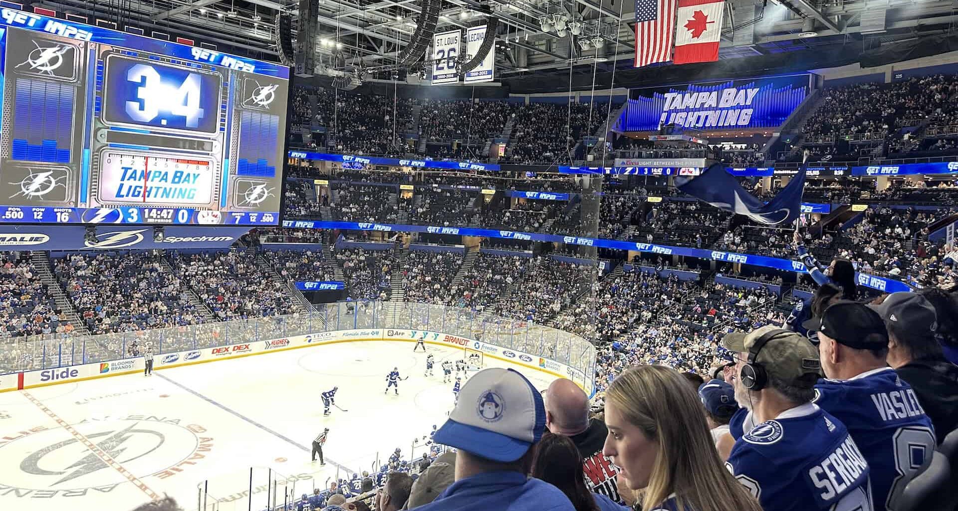 multiple hockey players on the ice in blue uniforms during a Tampa Bay Lightning home game