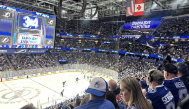 multiple hockey players on the ice in blue uniforms during a Tampa Bay Lightning home game