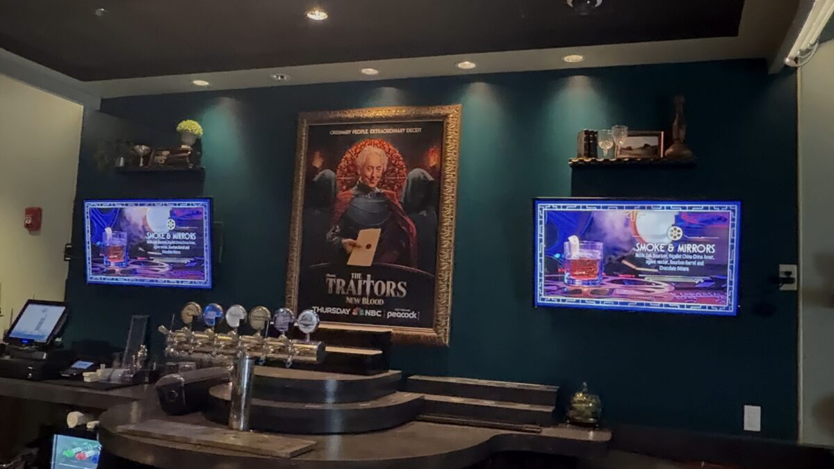 The Traitors upstairs bar area with menu boards and poster
