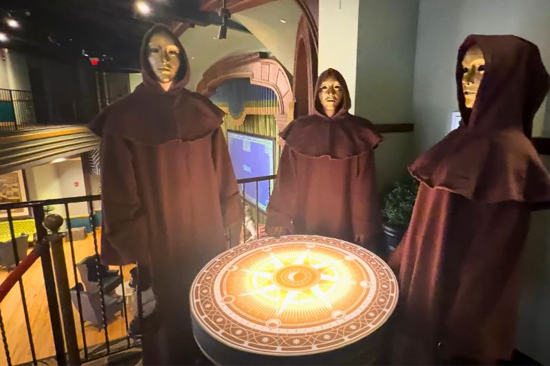 The Traitors upstairs bar cloaked figures and themed table