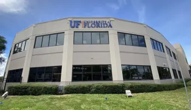 A tan building with the University of Florida logo on the top