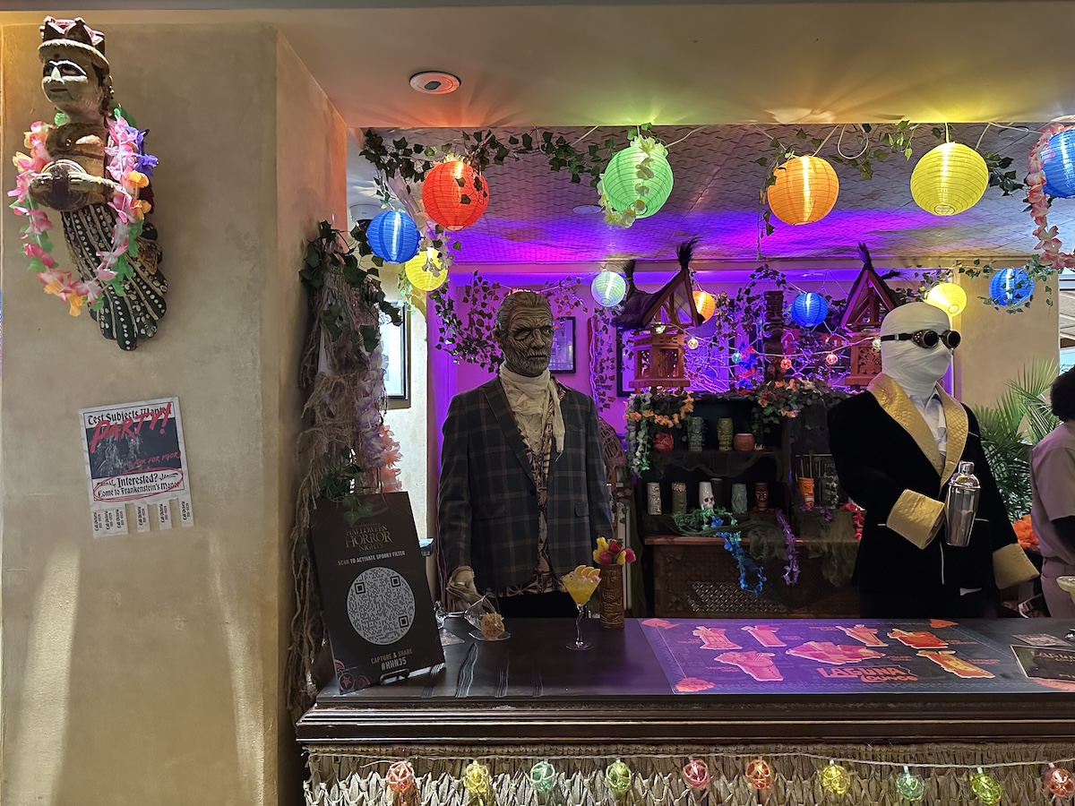 Invisible Man shakes up some cocktails at his bar