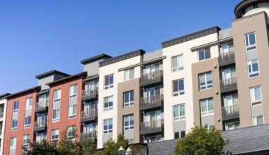 Exterior of a multistory apartment building with balconies and mixed exterior finishes.