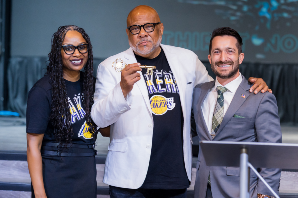 Dr. James R. Doggette Sr. (center) holds the key to the city presented to him by Apopka Mayor Nick Nesta (right) during an Aug. 22 farewell service at The Well Activity Center. Doggette’s wife, Erin, joins them for the presentation. Doggette is leaving Patmos Chapel Seventh-day Adventist Church after 10 years as senior pastor.