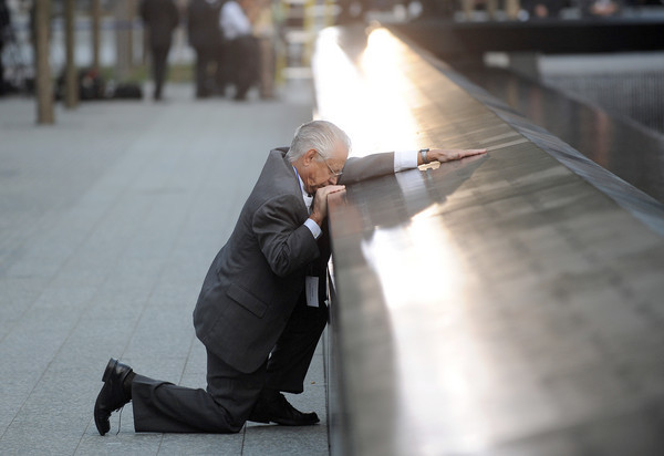 Robert Peraza, who lost his son Robert David Peraza, pauses at his son's name at the North Pool of the 9/11 Memorial on Sept. 11, 2011.
