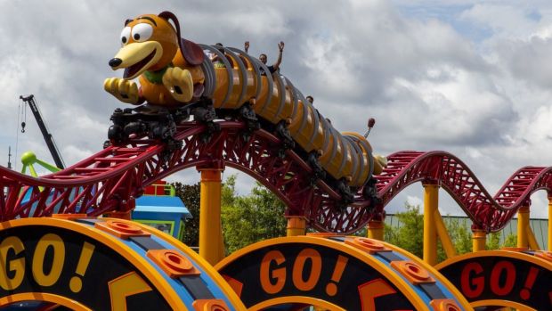 Slinky Dog Dash slinks by with visitors aboard during the grand opening of Toy Story Land at Disney''s Hollywood Studios on Saturday, July 30, 2018.