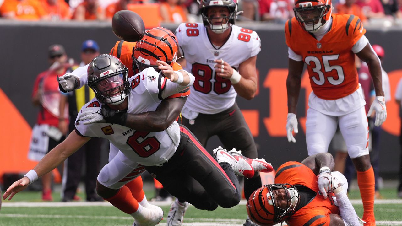 Cincinnati Bengals linebacker Barrett Carter (49) forces a fumble of Tampa Bay Buccaneers quarterback Baker Mayfield (6) during an NFL football game in Cincinnati, Sunday, Sept. 13, 2026. (AP Photo/Kareem Elgazzar)