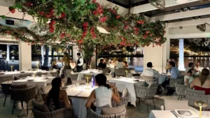Cantina La Veinte dining room with bougainvillea overhead and Biscayne Bay views