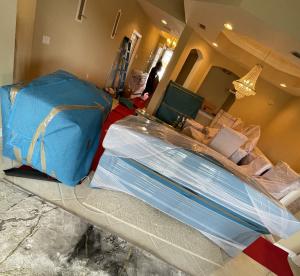 Fully wrapped furniture and floor protection set up throughout a Fort Myers home during a move